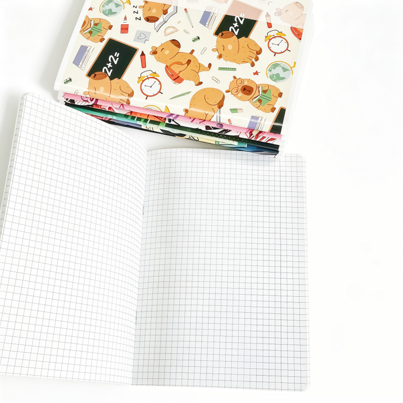 Close-up of multi-color lined pages inside a saddle stitched exercise book showing blue, green, orange, and pink ruling 