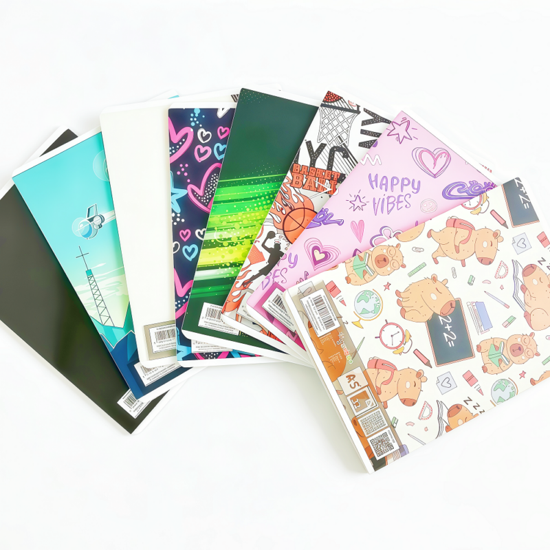Saddle stitched student notebook by Colorfly with multi-color lined pages and durable cover on a classroom desk 